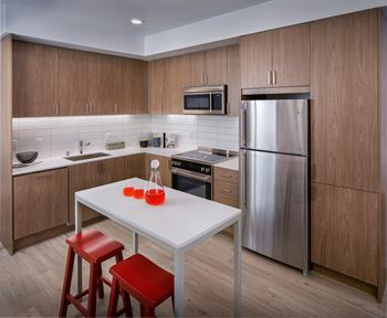 A modern kitchen with a table and chairs.