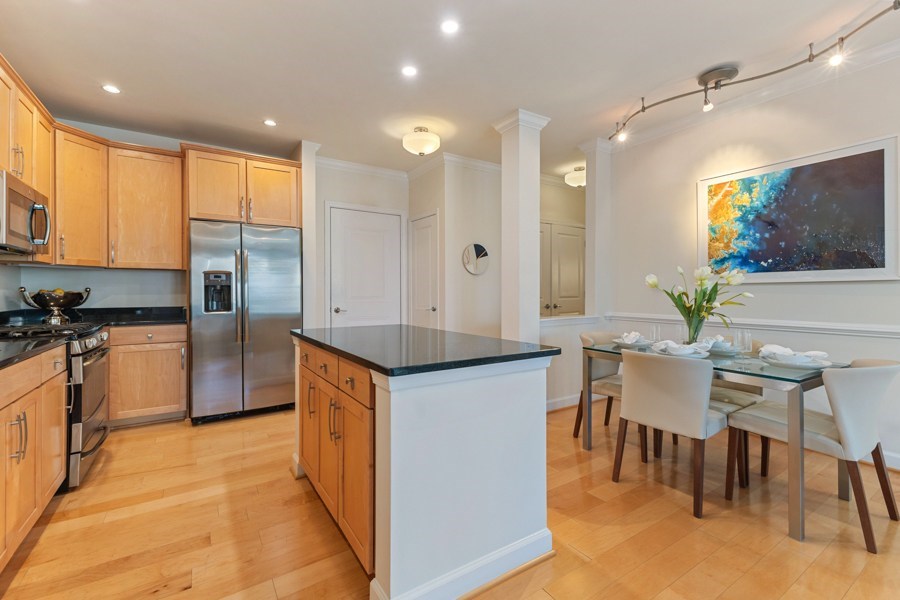 Open floor plans with crown molding in kitchen, living and dining rooms