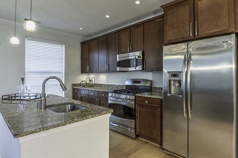 a kitchen with stainless steel appliances and granite counter tops