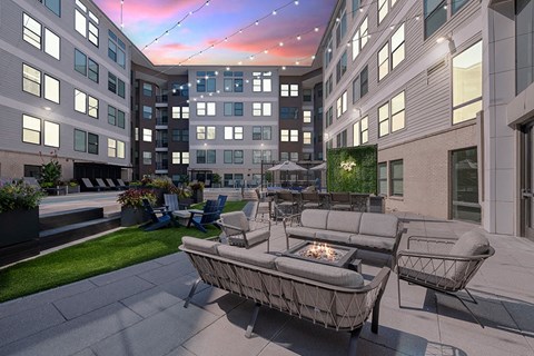 Poolside firepit area includes TV and grilling area