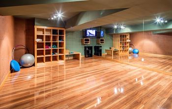 A room with wooden floors and exercise equipment.