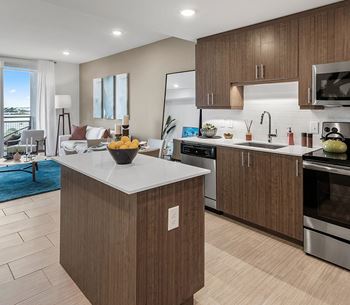 A modern kitchen with a wooden island and stainless steel appliances.