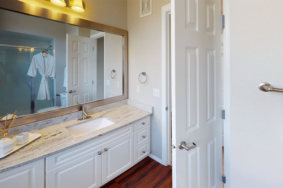 Bright bathrooms with granite counters and upgraded fixtures