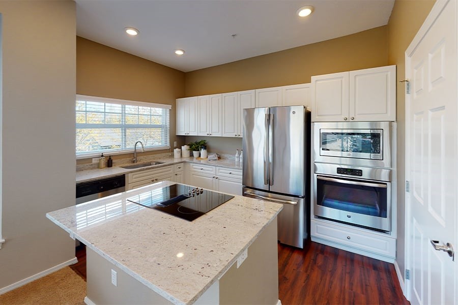 Modern kitchen with granite countertops and stainless steel appliances
