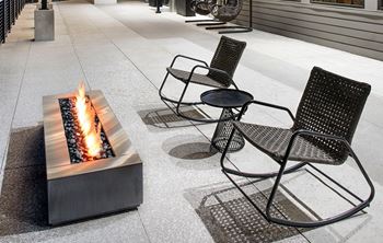 A modern outdoor seating area with a fire pit.