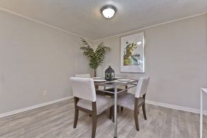 A dining room with a table and chairs.