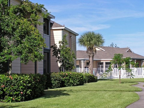 A building with a white picket fence in front of it.