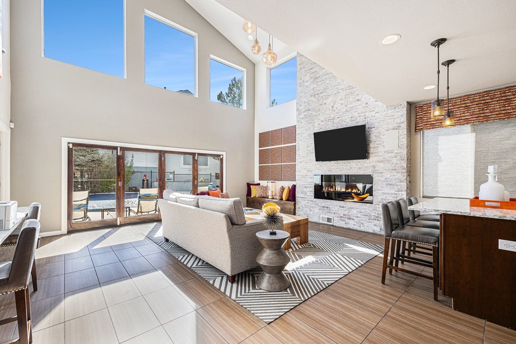 A modern living room with a fireplace and a television.
