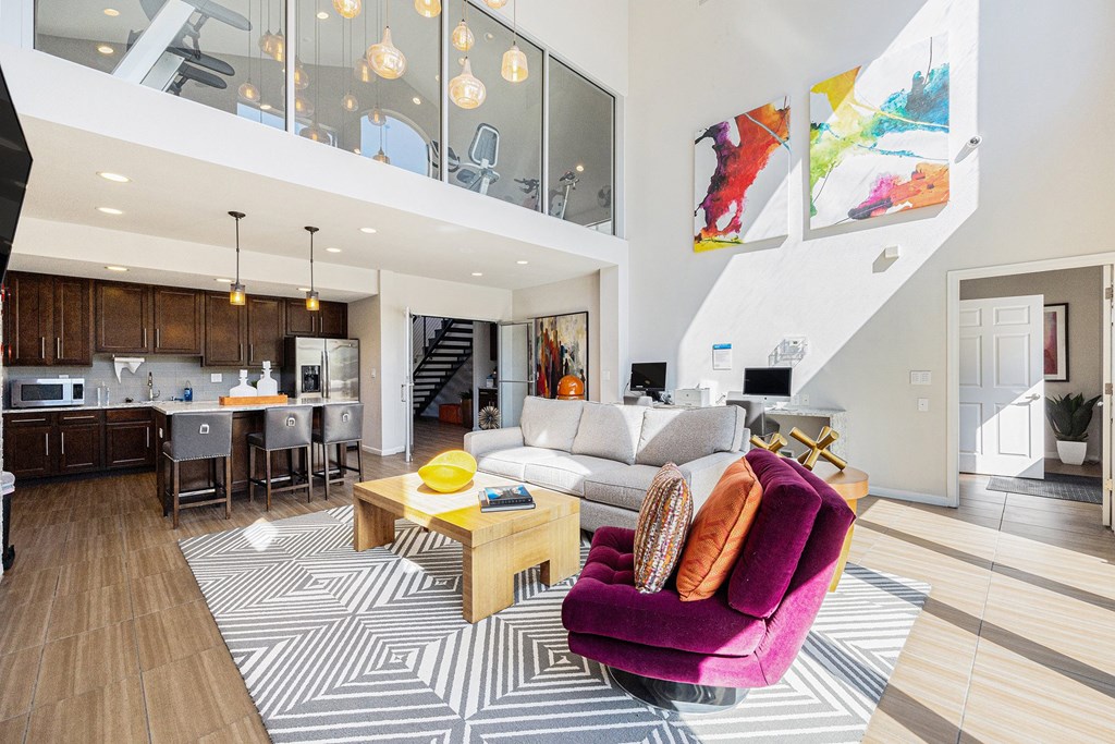 A modern living room with a purple armchair and a wooden coffee table.
