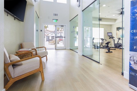 a waiting room at a hospital with chairs and glass doors