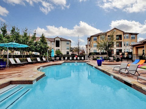 Pool with lounge chairs and umbrellas