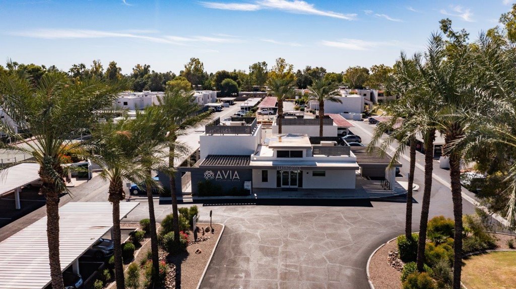 A view of a parking lot with a building that has the word AVIA on it.