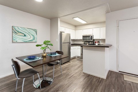 an open kitchen and dining room with a table and chairs