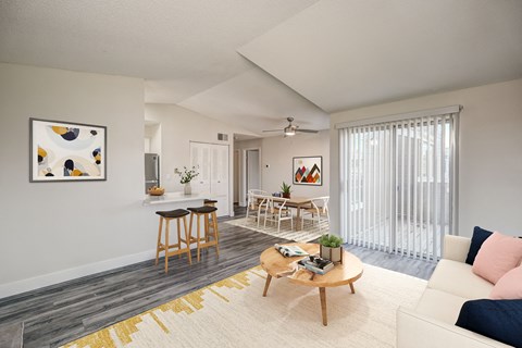 A living room with a white couch and a coffee table.