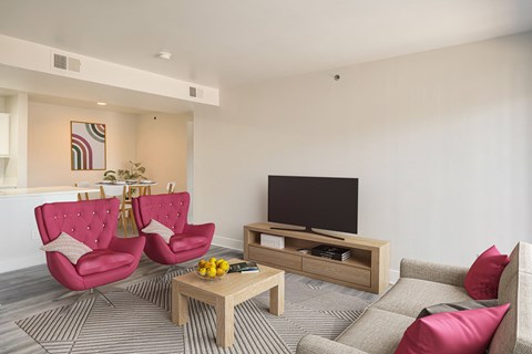 a living room with a couch and chairs and a television