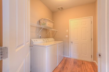 a laundry room with a washer and dryer - Photo Gallery 6