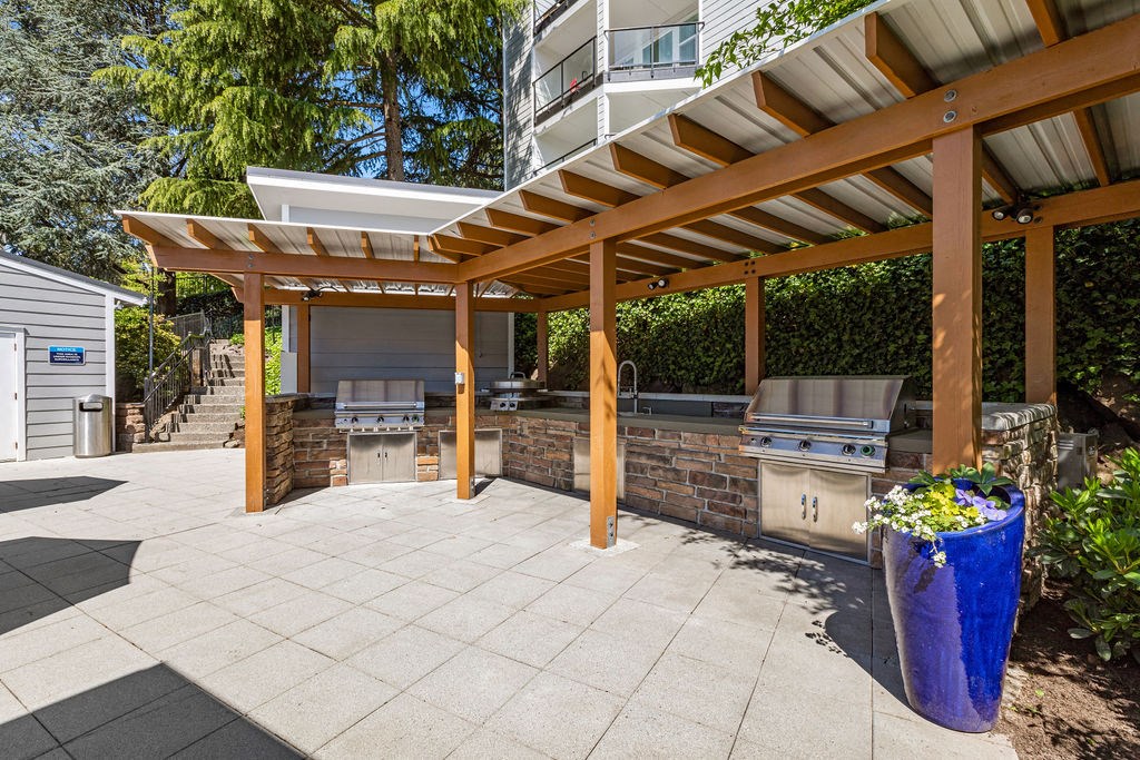 a patio with a barbecue grill and a pergola