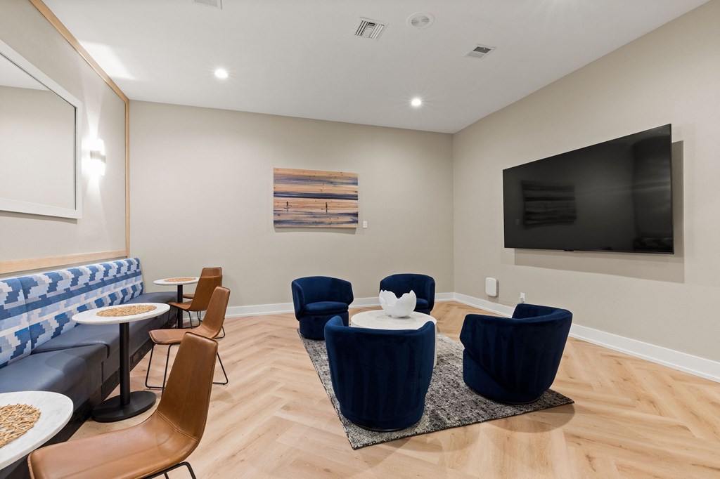 A living room with a blue couch and a television.