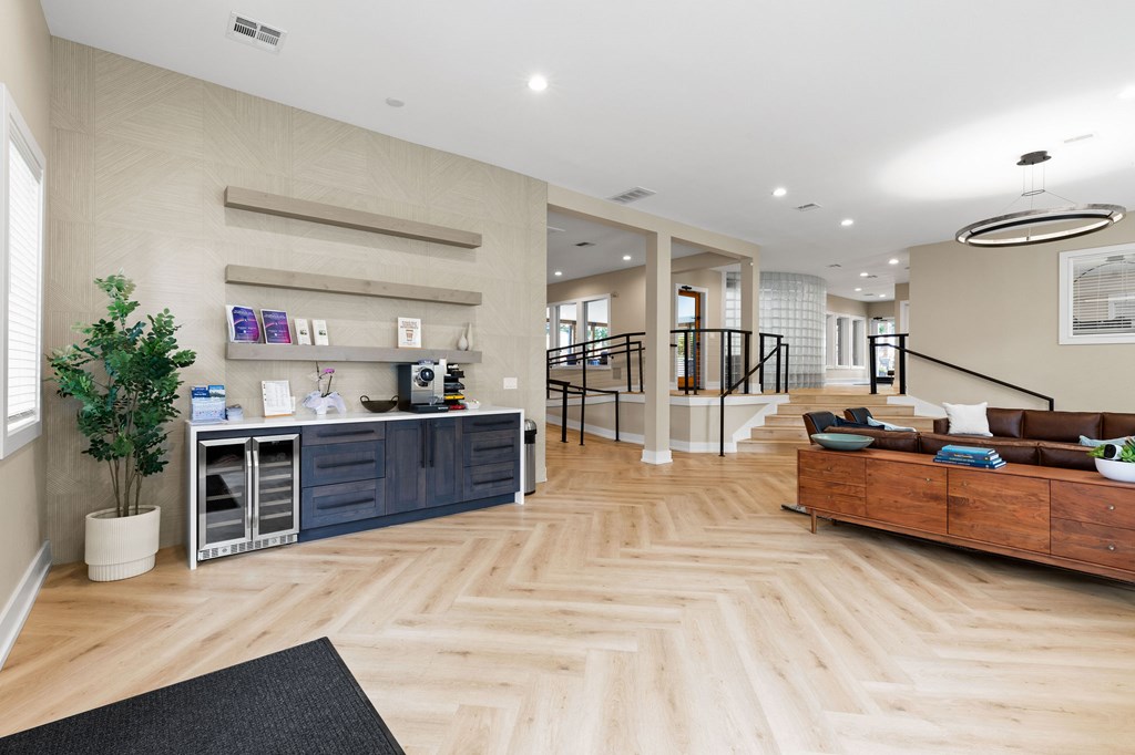 A well-lit, spacious interior with wooden flooring and a variety of furniture and decor.