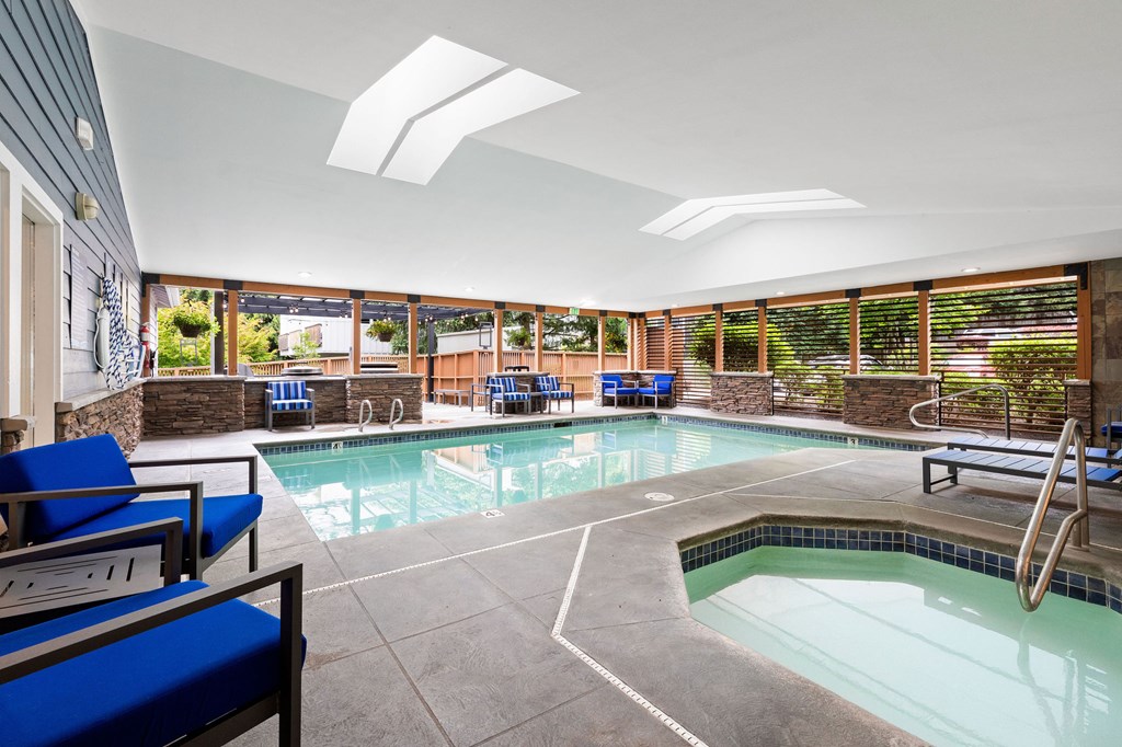 A large indoor swimming pool with a slide.