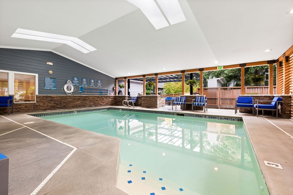 A large indoor swimming pool with a glass bottom.