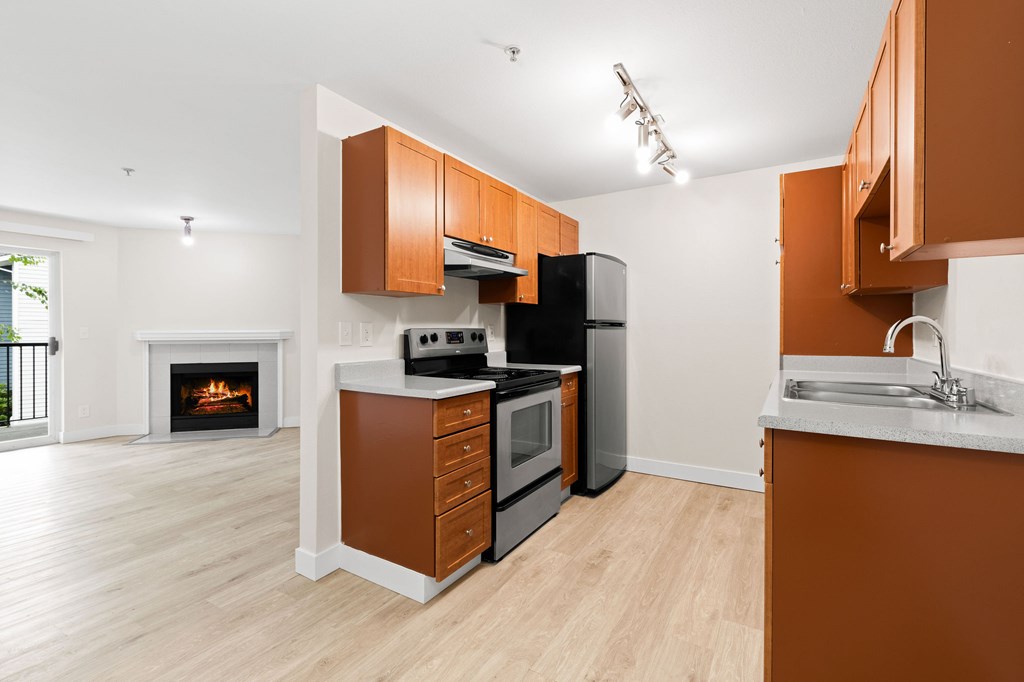 A kitchen with brown cabinets and a white counter.