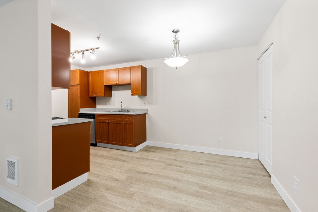 A kitchen with brown cabinets and a white countertop.