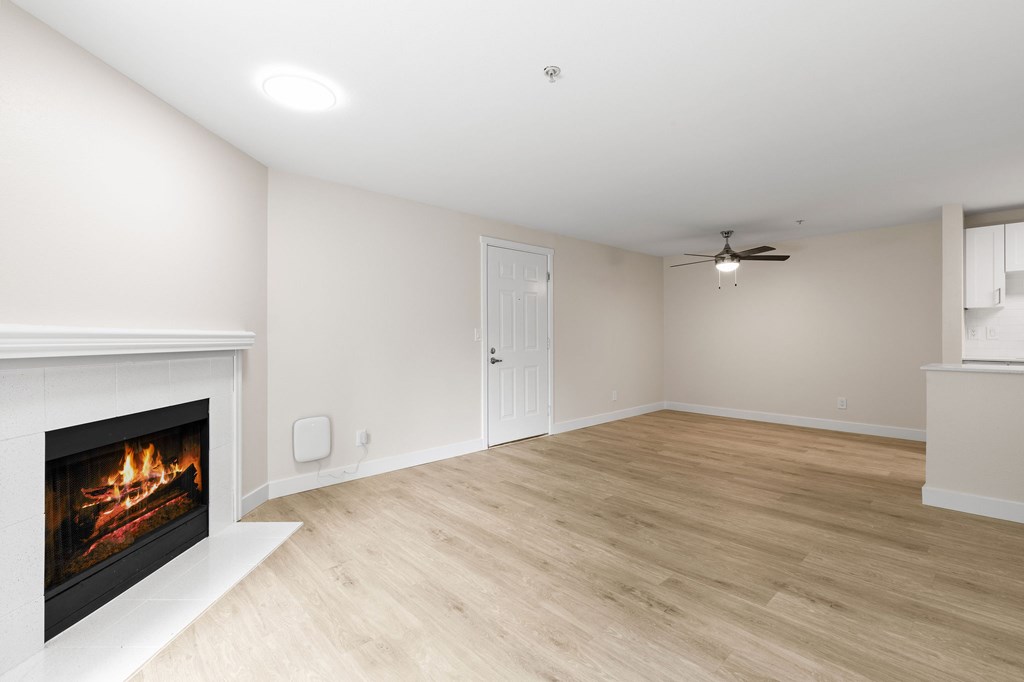 A room with a fireplace and a ceiling fan.