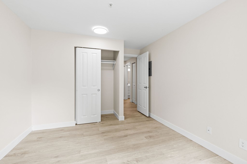 A white door is in the middle of a hallway.