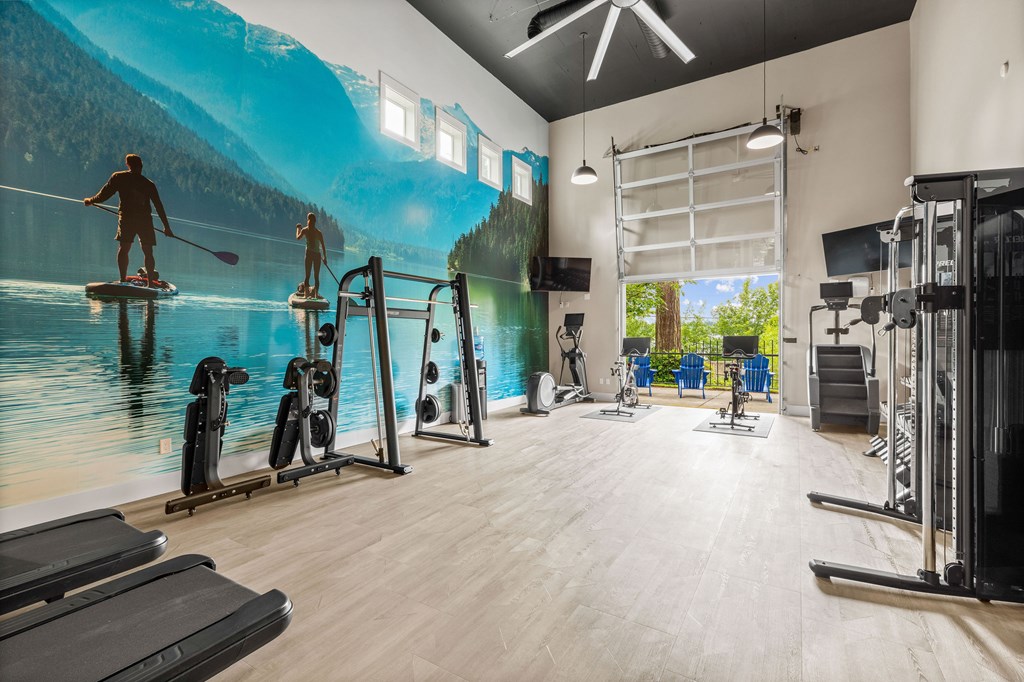 A gym with a large mural of people kayaking on a lake.