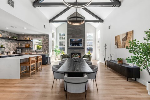 A modern dining room with a large table and chairs.