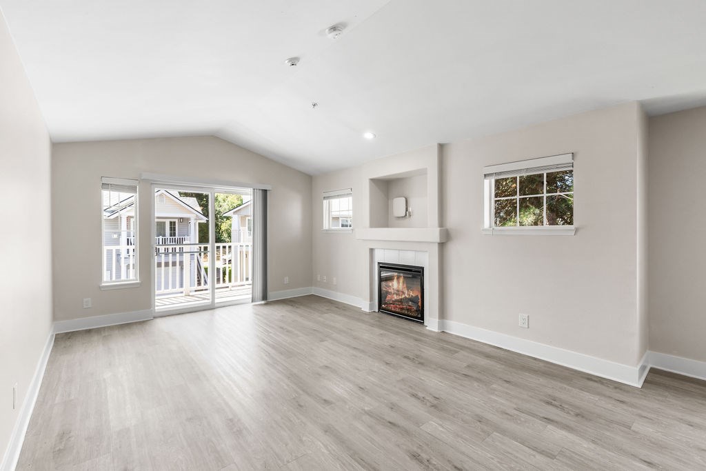 A spacious living room with a fireplace and sliding glass doors.