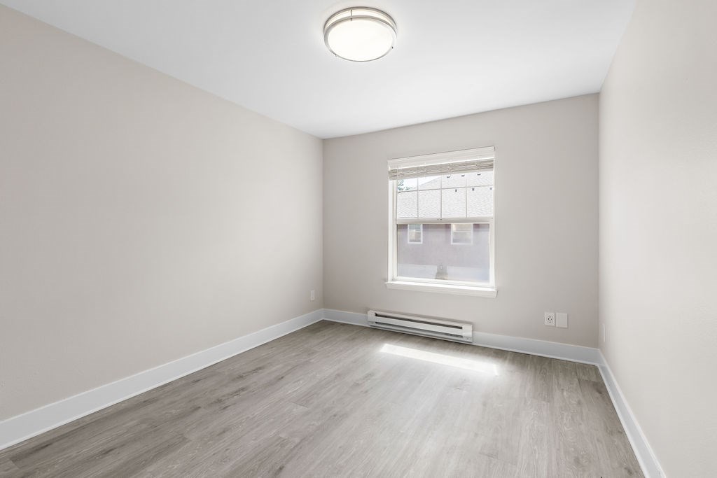 A room with a window and a radiator on the wall.
