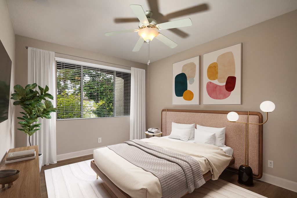 a bedroom with a bed and a ceiling fan
