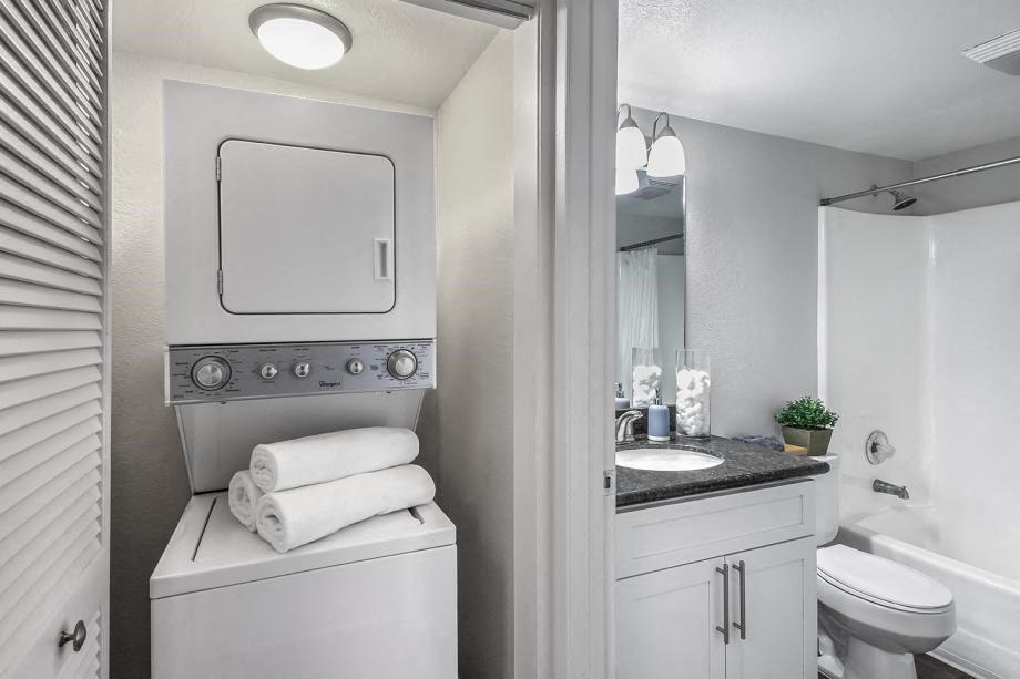 Newport Palms Apartments Model Bathroom and Laundry Closet with Stacked Washer and Dryer