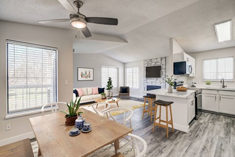 A modern kitchen with a dining table and chairs in the foreground.