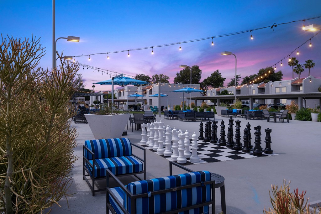 a giant chess board is set up on a patio
