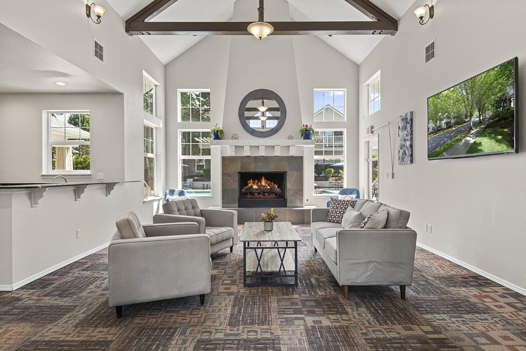 a living room with couches and chairs and a fireplace