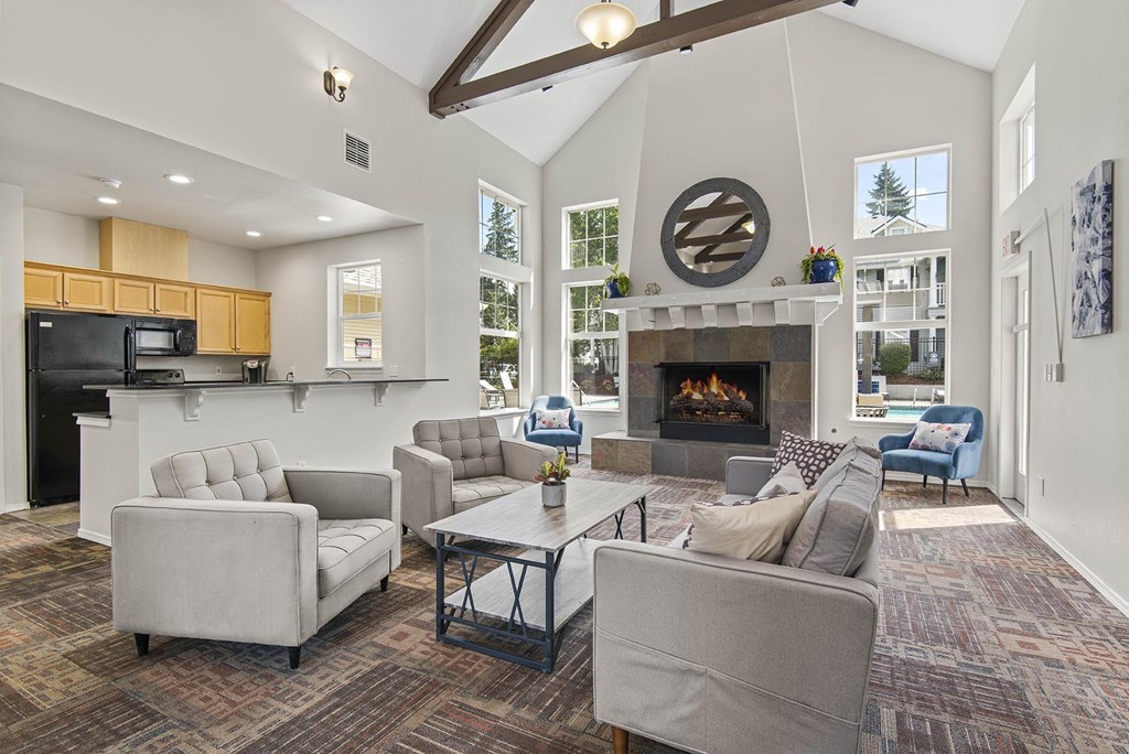 a living room with couches and chairs and a fireplace
