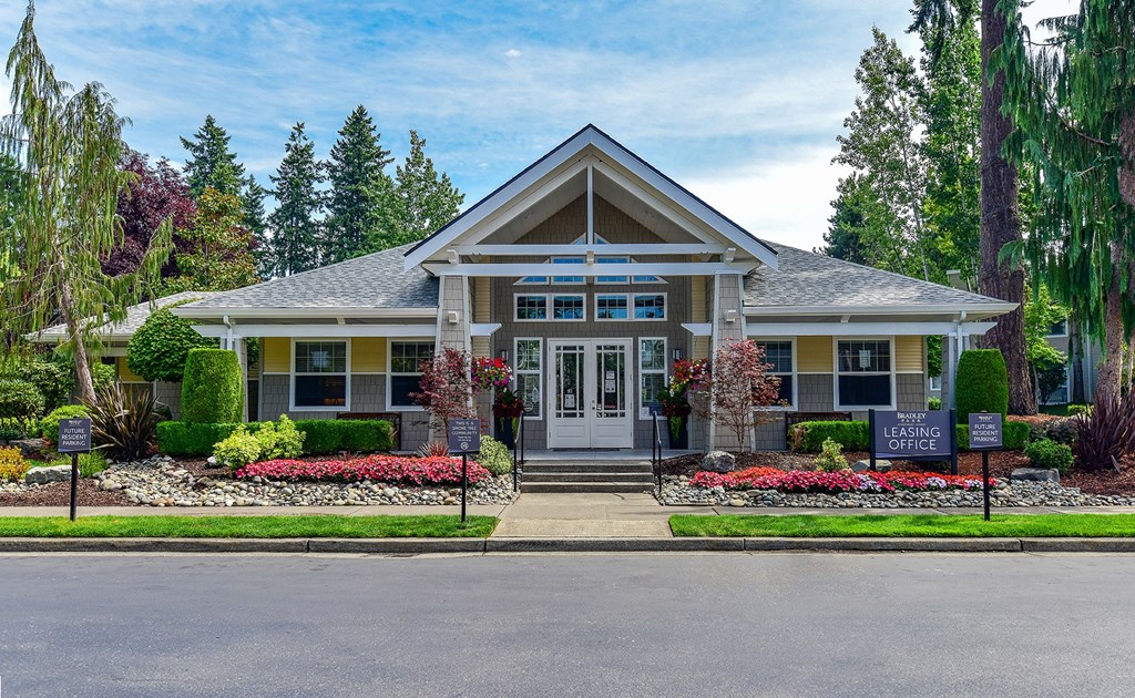 the front of a house with a porch and a street in front of it