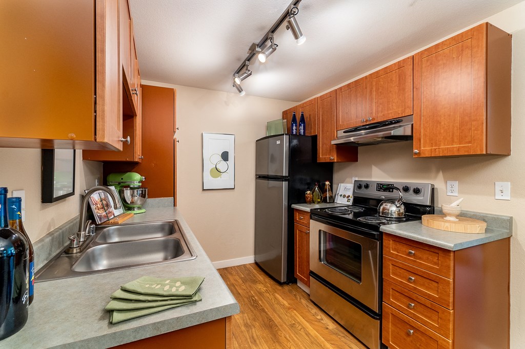 a kitchen with wooden cabinets and stainless steel appliances