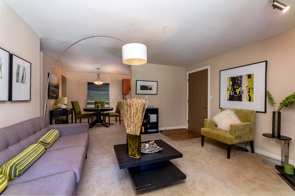a living room with a purple couch and a yellow chair