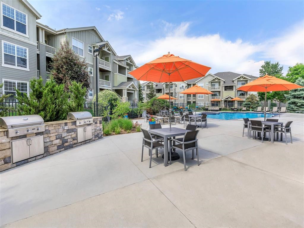 our apartments have a large patio with tables and umbrellas