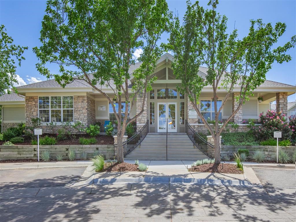 the front entrance of a house with trees