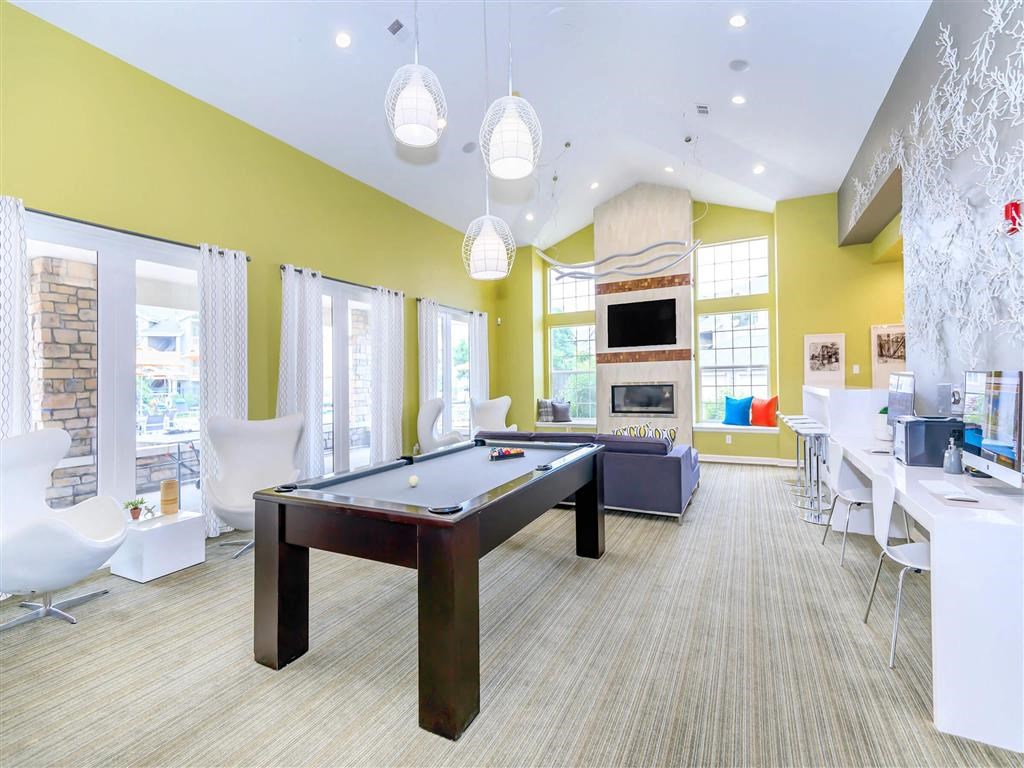 a clubhouse with a pool table and a living room