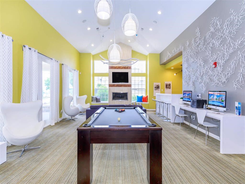 a game room with a pool table and a television