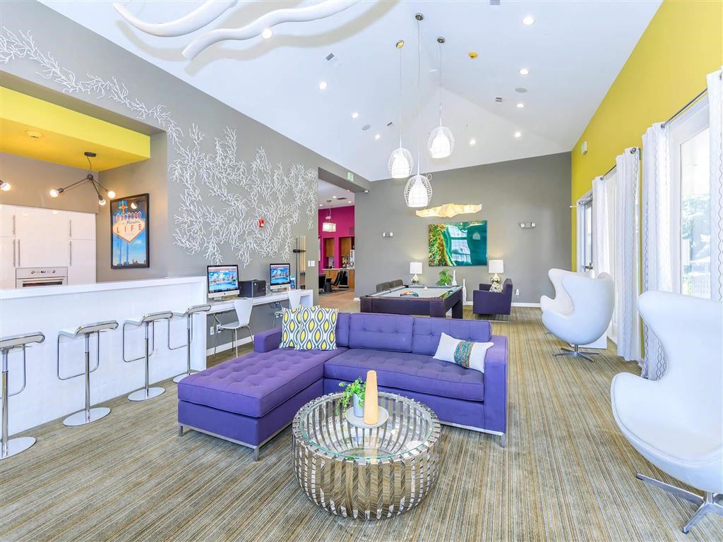 a living room with a purple couch and a table