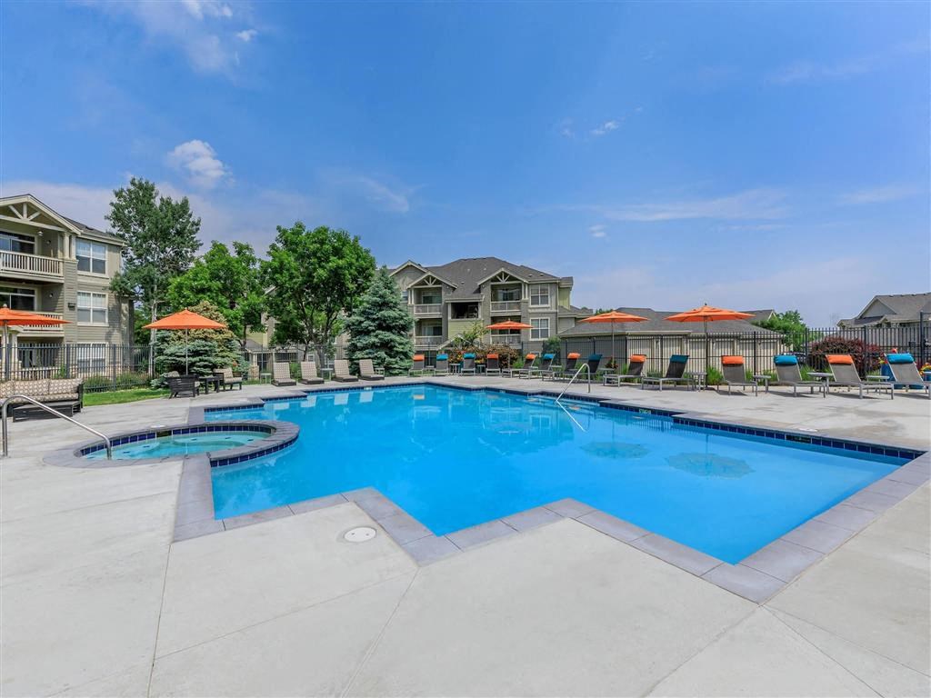 a swimming pool with apartments in the background