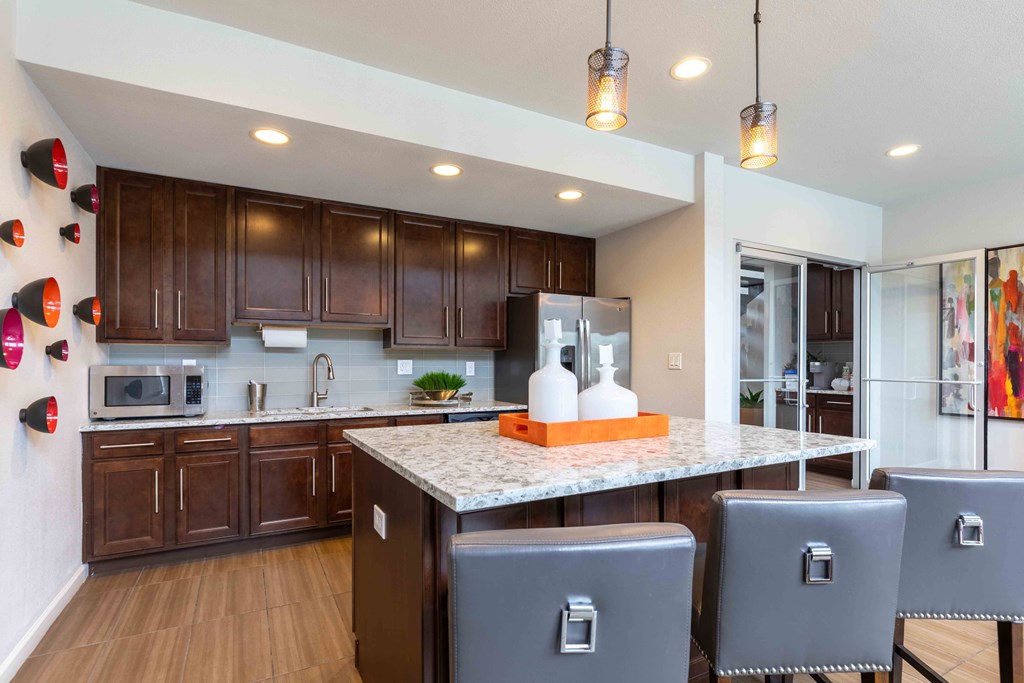 a large kitchen with a marble counter top