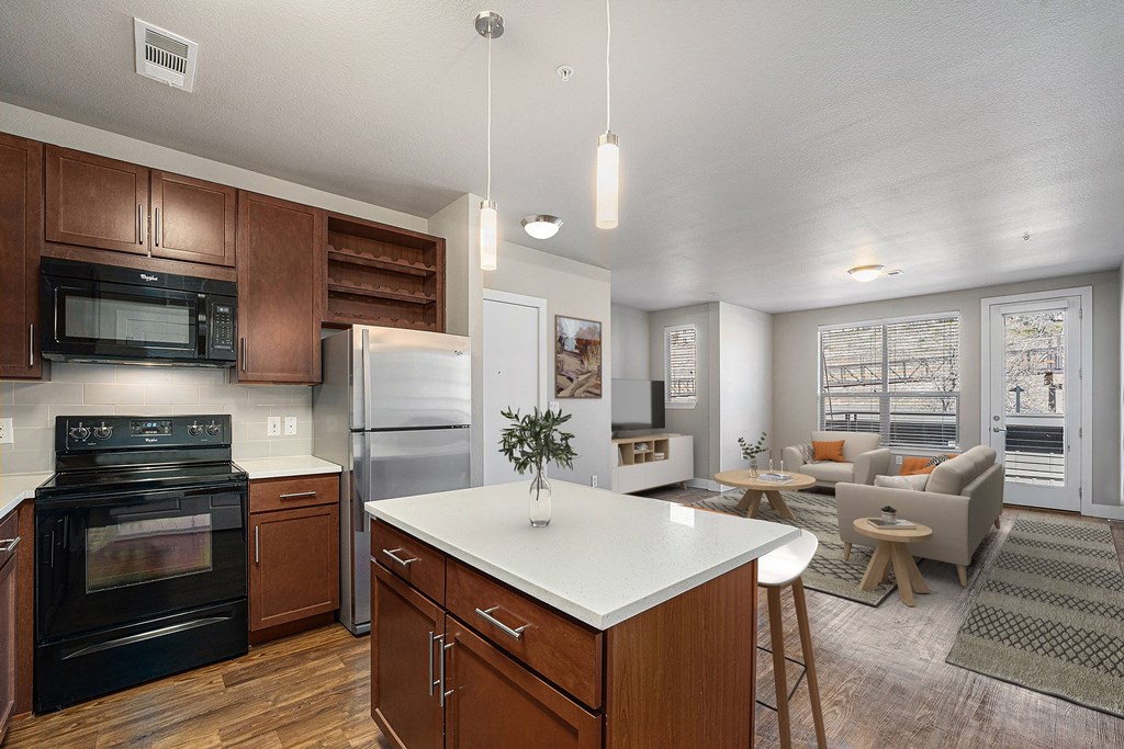 A modern kitchen with dark wood cabinets and a white island.